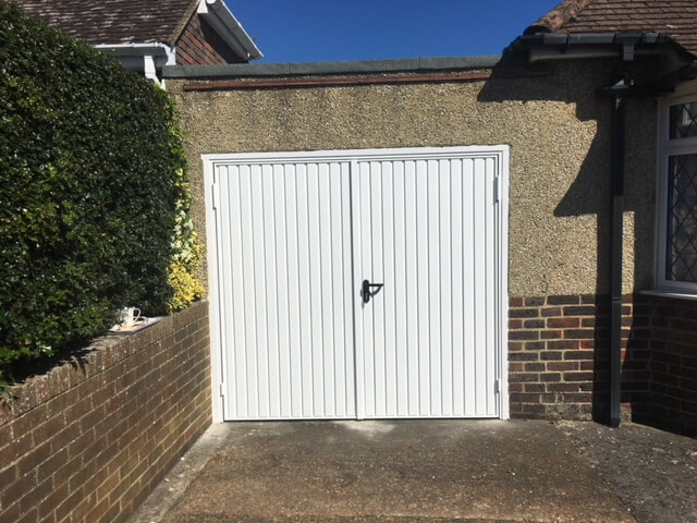 White garage door with in-built smaller door